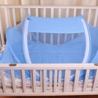 Baby sleeping in foldable bed with net