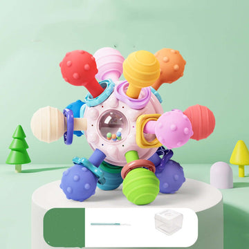 Baby grasping colorful puzzle ball