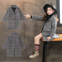 Close-up of a girls' houndstooth coat showcasing the classic pattern.
