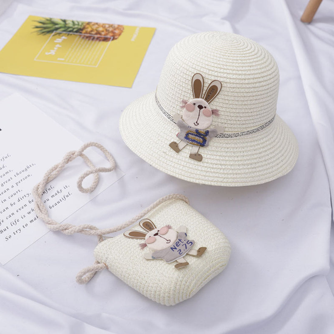 Kids wearing a summer straw hat with rabbit decoration