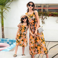Mother and daughter in beach vest tops and long skirts