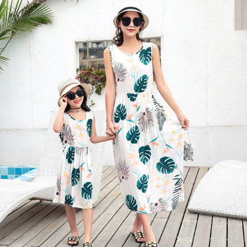 Mother and daughter wearing matching beach vest and long skirt outfits