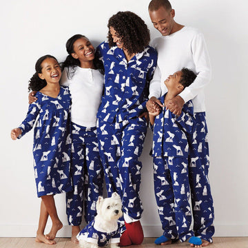 Parent and child wearing matching printed pajamas