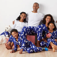 Family in matching two-piece pajamas with casual prints