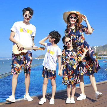 Family wearing matching summer outfits with dresses and T-shirts