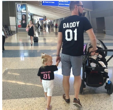Parent and child in matching pink outfits with word designs