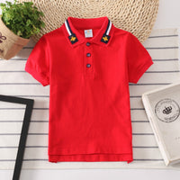 Boys' collared shirt with a two-button placket, available in multiple solid colors.