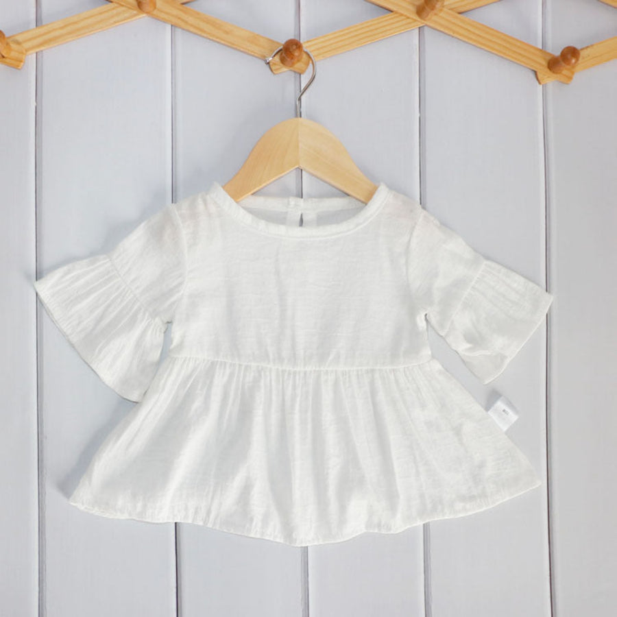 Adorable baby girl top with playful designs.