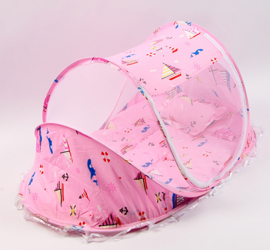 Pink baby bed with pillow and mosquito net