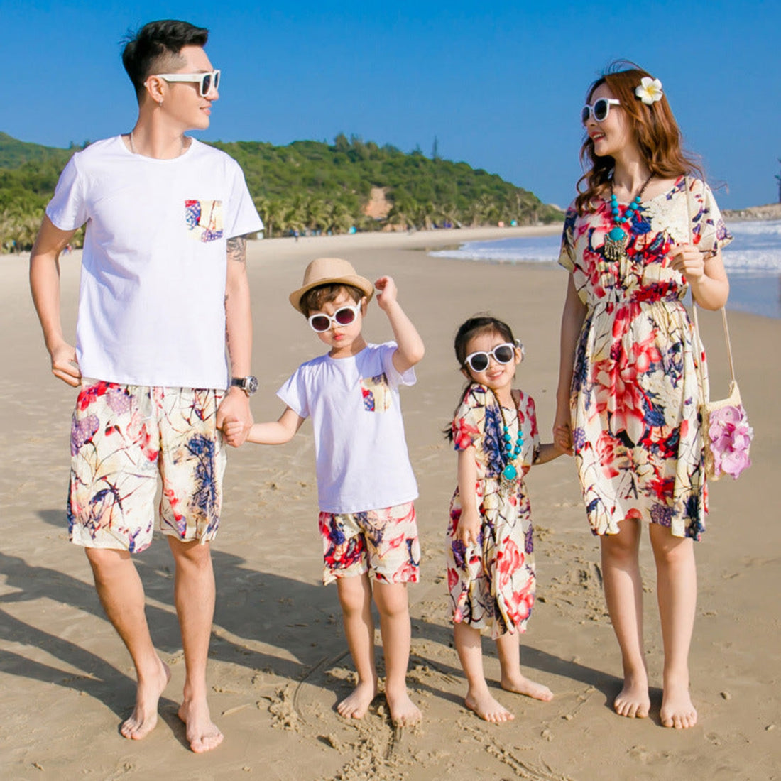 Family of four wearing matching outfits in a beach