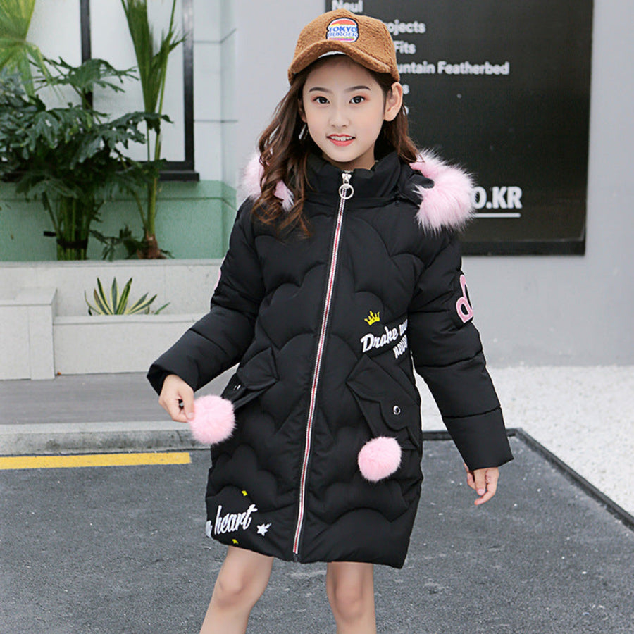 A girl playing outside in a durable cotton-padded jacket.