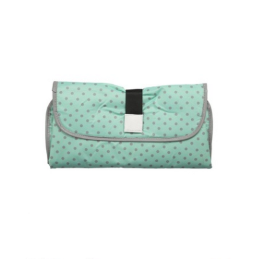 Mom using portable changing pad clutch