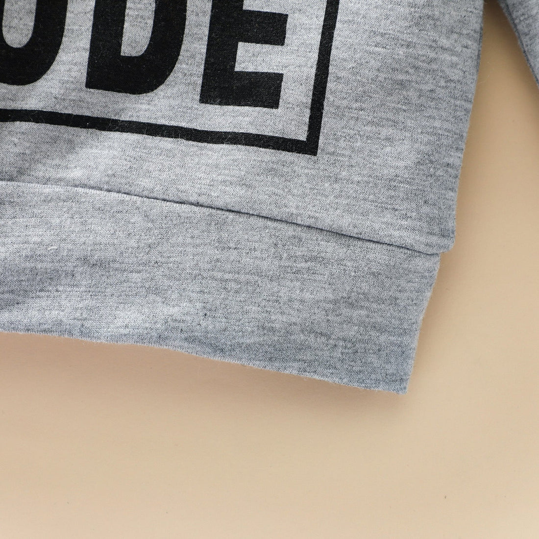 Trendy grey sweatshirt for boys featuring stylish letter graphics.