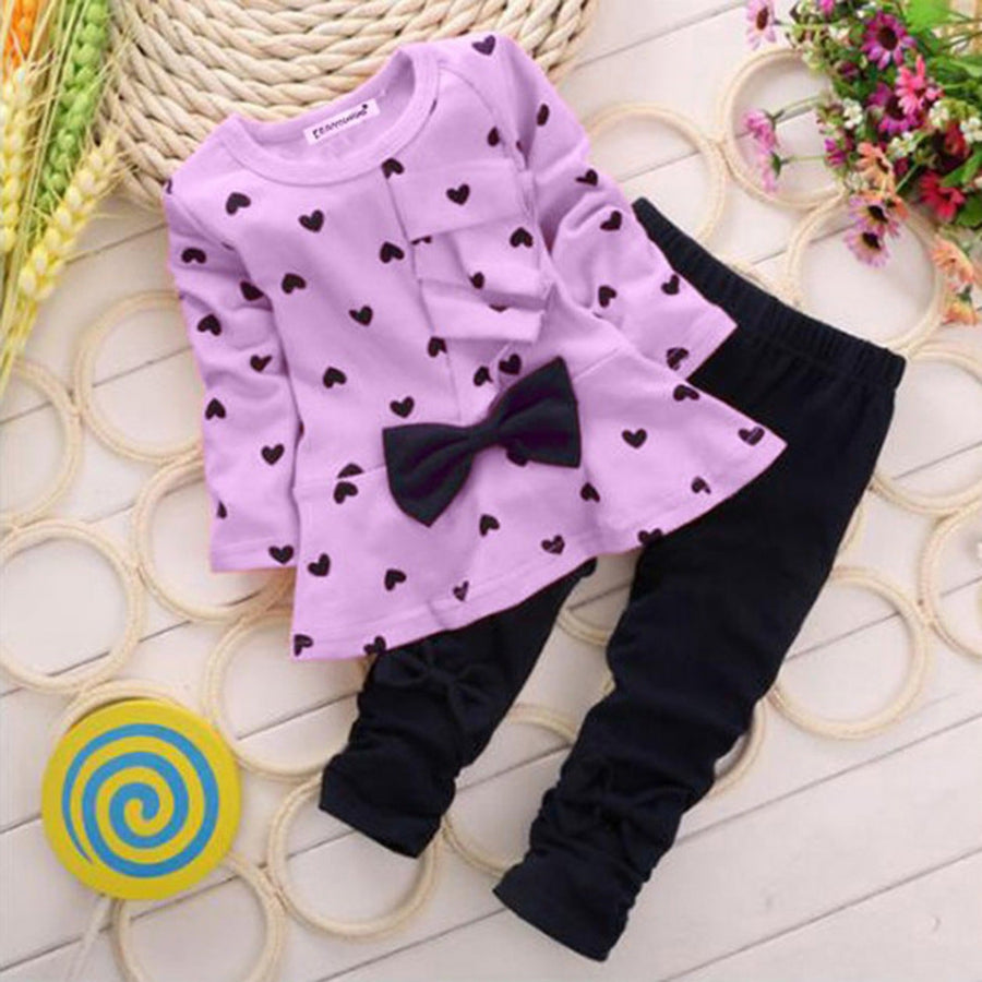 Detailed view of a cute bow on a girls clothing set.